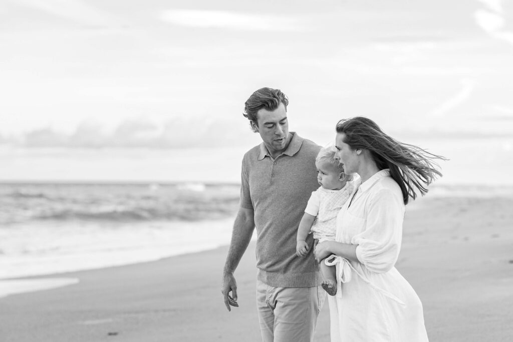 Mom and kids laughing in the sand during relaxed beach family photos in Jacksonville