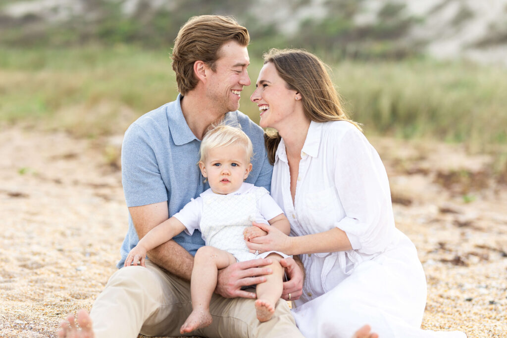 Family enjoying a sunset photoshoot on a beach in Jacksonville.