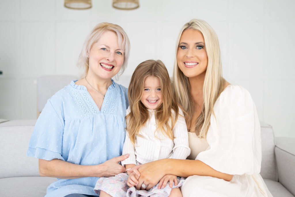 Grandmother, mother, and child posing together during a LINEAGE generational portrait session at Tracy Lynn Photography in Jacksonville FL