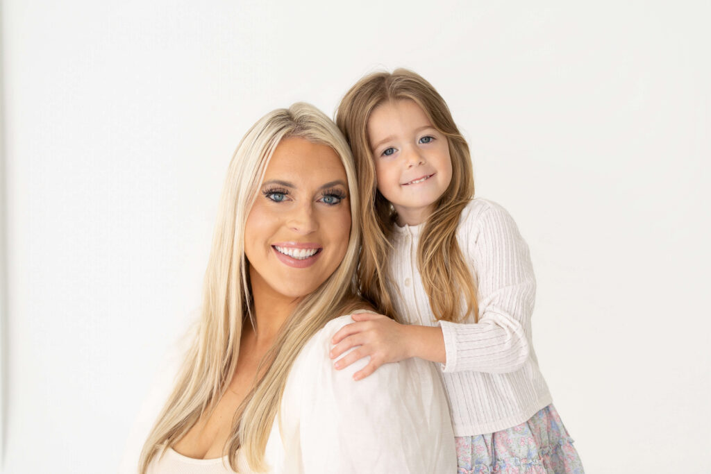 Mother holding child while grandmother looks on during a generational portrait session at Tracy Lynn Photography Jacksonville